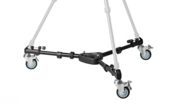 Four-wheeled camera dolly with a central hub and four swivel casters on a black metal frame.