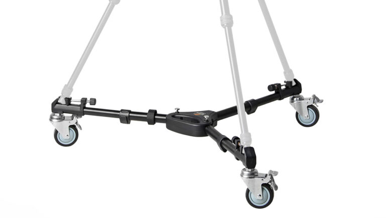 Four-wheeled camera dolly with a central hub and four swivel casters on a black metal frame.