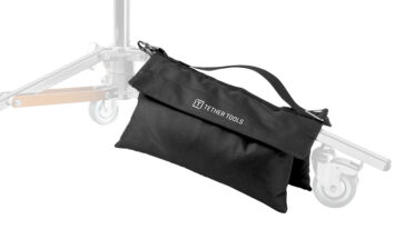 Black tool pouch with 'TETHER TOOLS' logo hanging from a photography light stand, with a carrying strap visible