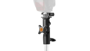 Adjustable camera mount with a star-shaped orange logo knob, clamped to a pole for securing a device such as a light or action camera