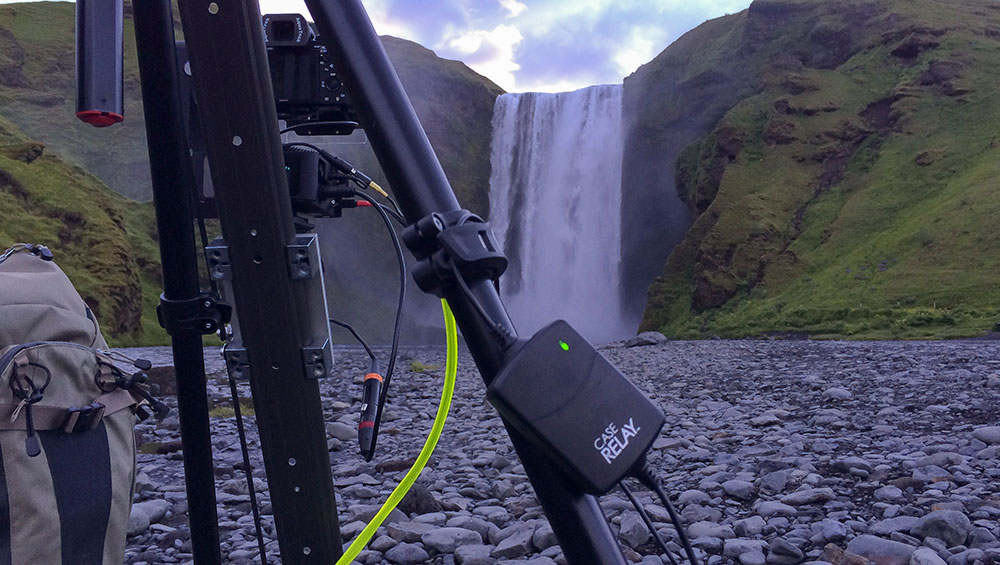 ONsite Relay A attached to a tripod in the foreground and a majestic waterfall in the background