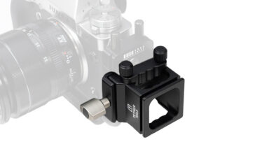 Close-up of a black clamp-on camera accessory attached to a Fujifilm camera, with two adjustment knobs on top.