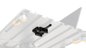 Black lever clamp mounted on a rail system atop a gray platform, likely part of a printer or CNC frame