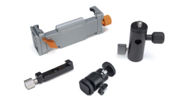 Set of camera mounting clamps and supports arranged on a white surface (Tether Tools components)