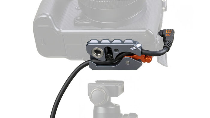 Close-up of a camera side rig with a quick-release clamp and attached cable.