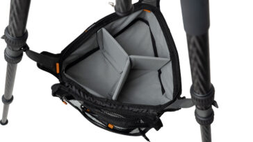 Open camera backpack with padded gray dividers for lenses and body gear.