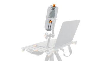 Camera rig with an articulated arm holding a tablet/phone mounted above a laptop on a wheeled base, for on-site shooting setups (informative)